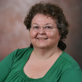 A woman is smiling at the camera