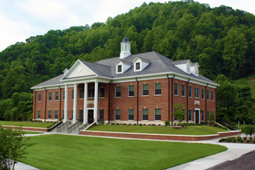 A building with a clock on the side of a road