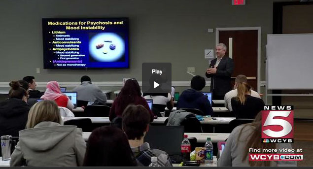 A group of people watching a television