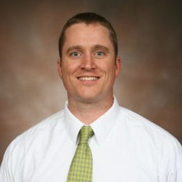 A man wearing a neck tie and a white shirt