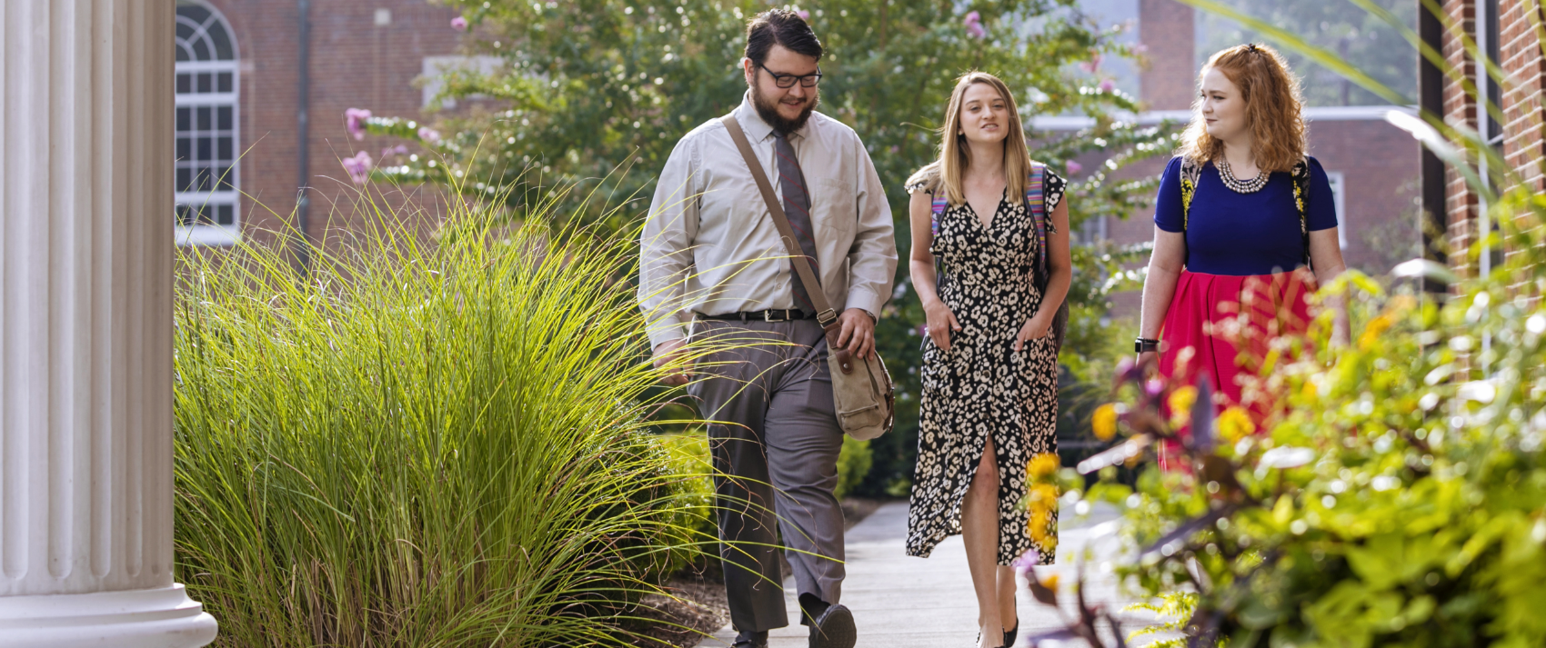 three students walking on college campus