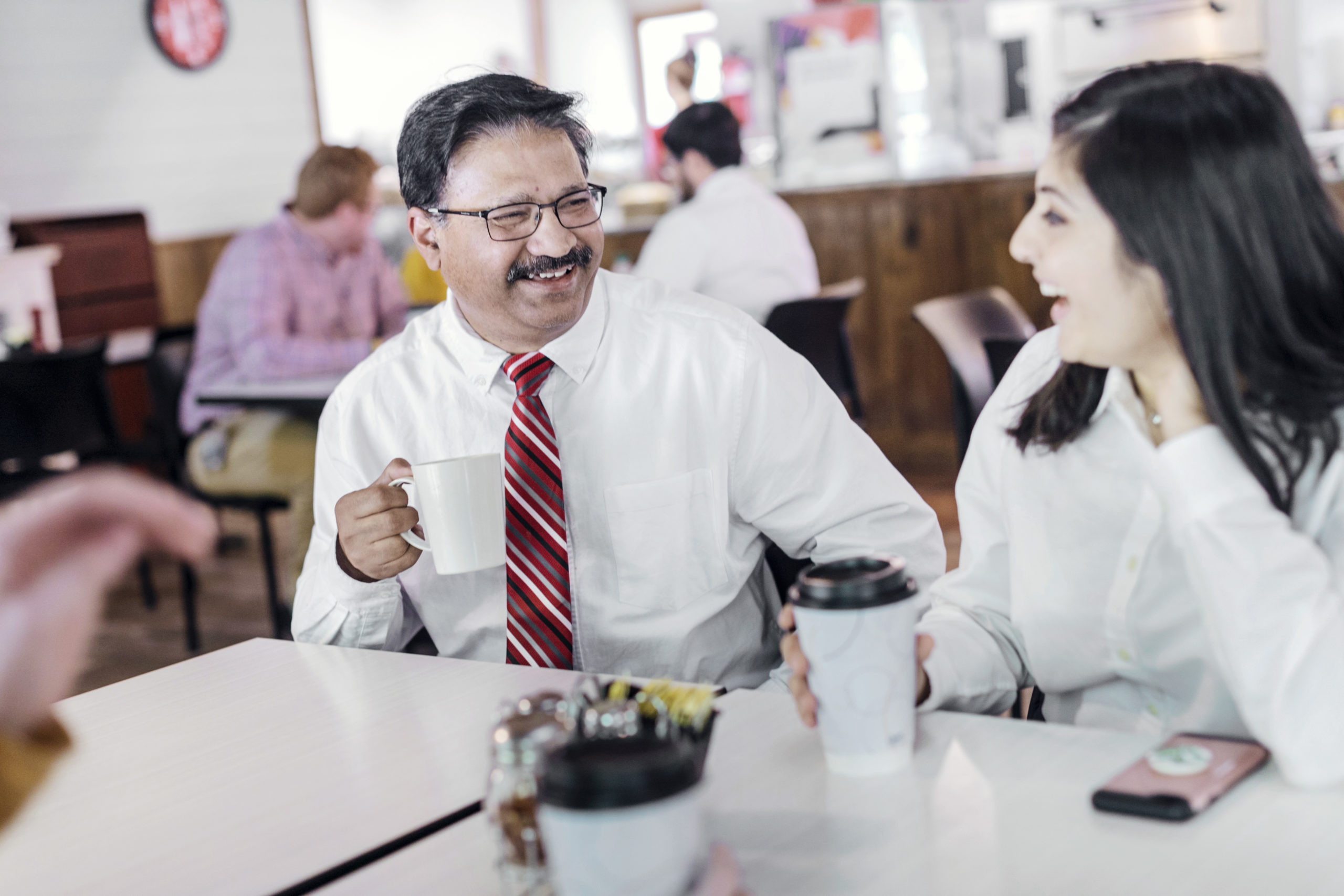 faculty laughing in cafeteria