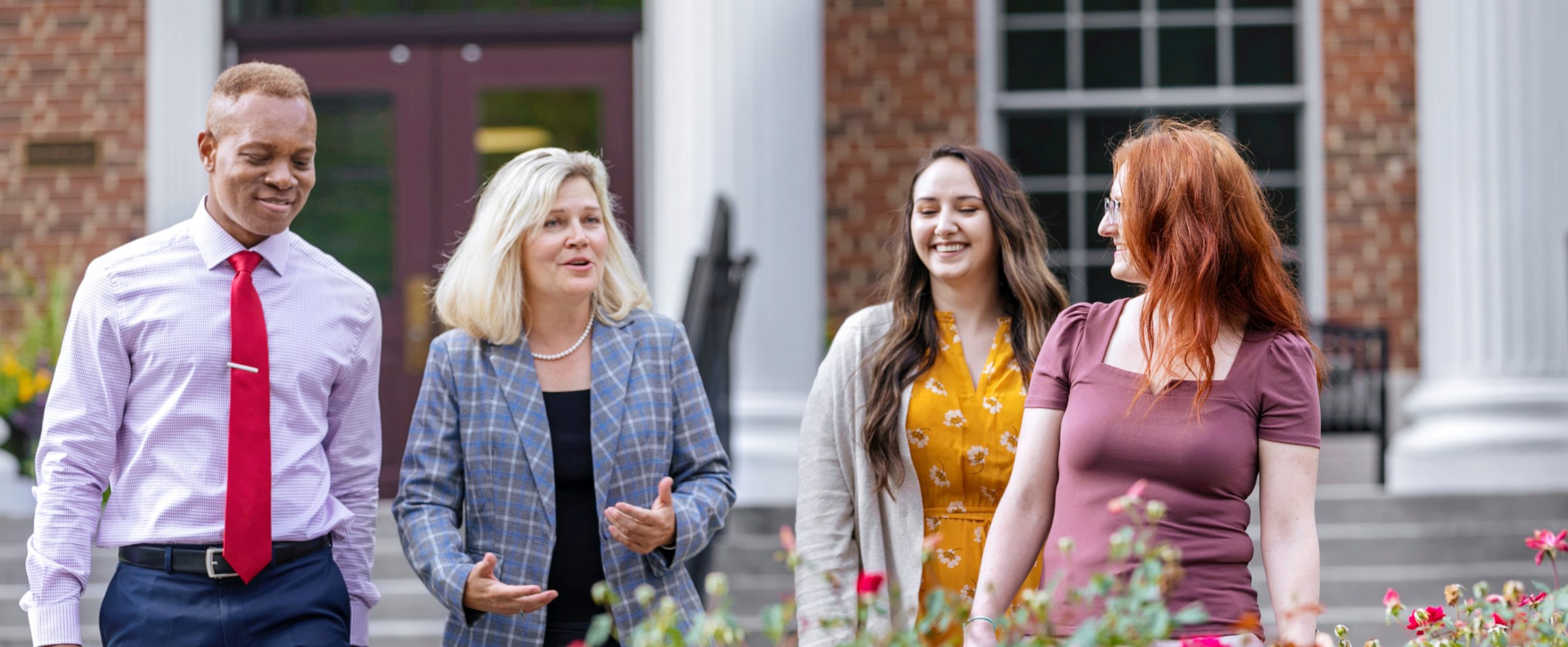 faculty and students talking