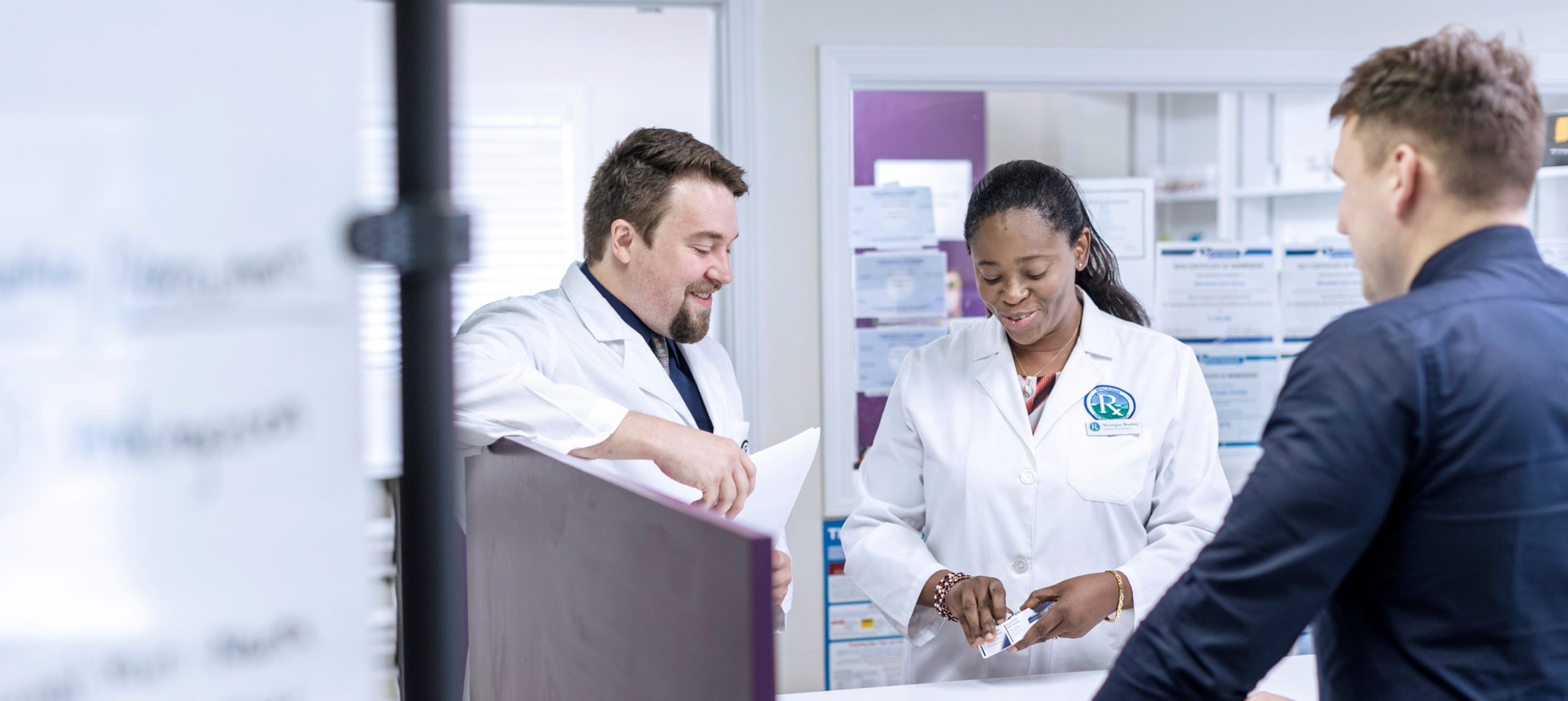 two pharmacists serving customer