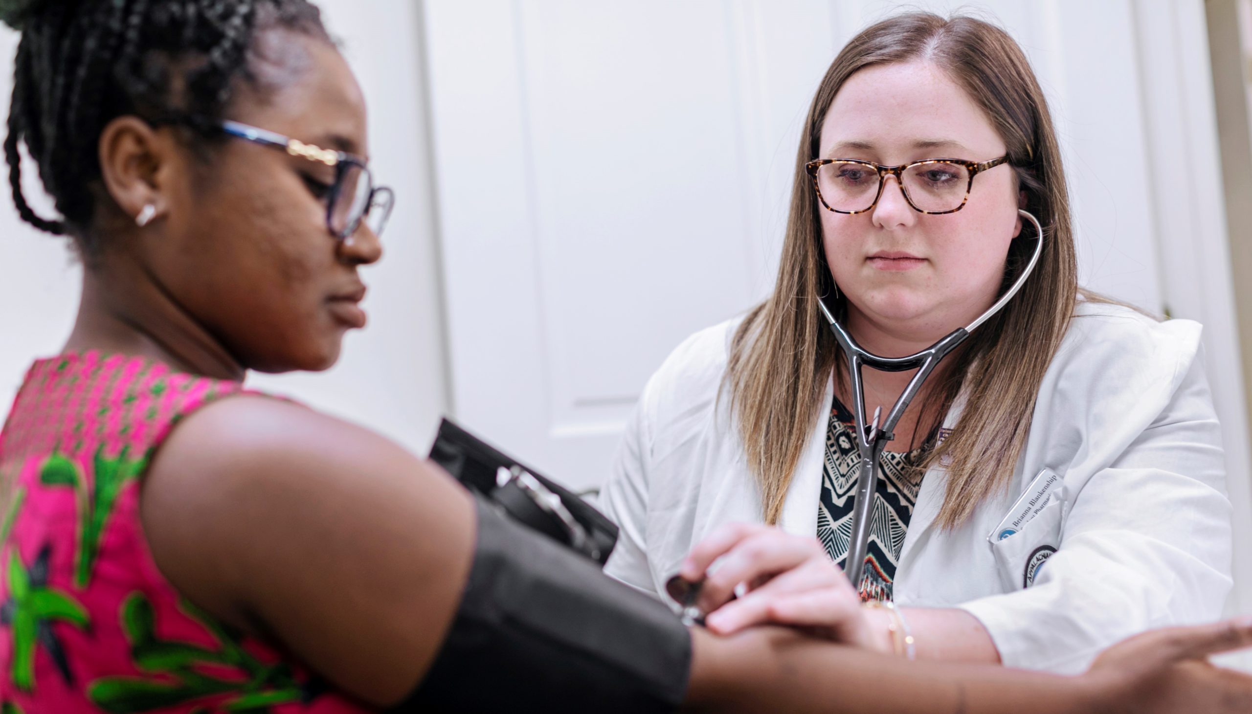 pharmacist taking blood pressure