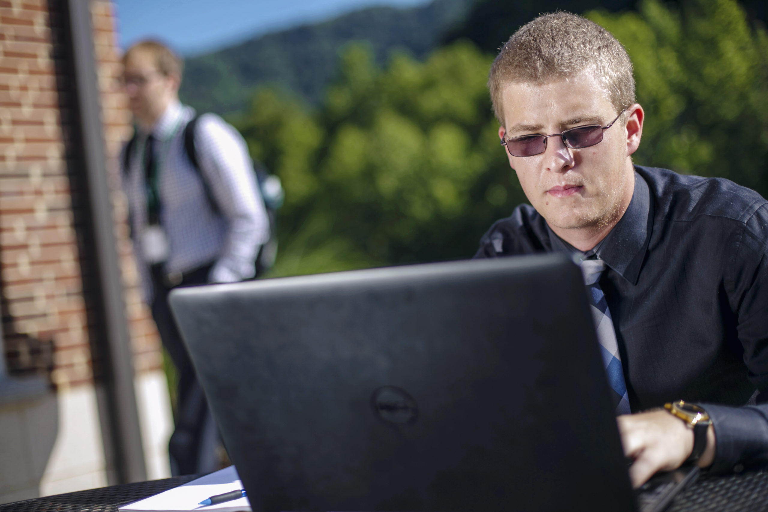 student on laptop outside