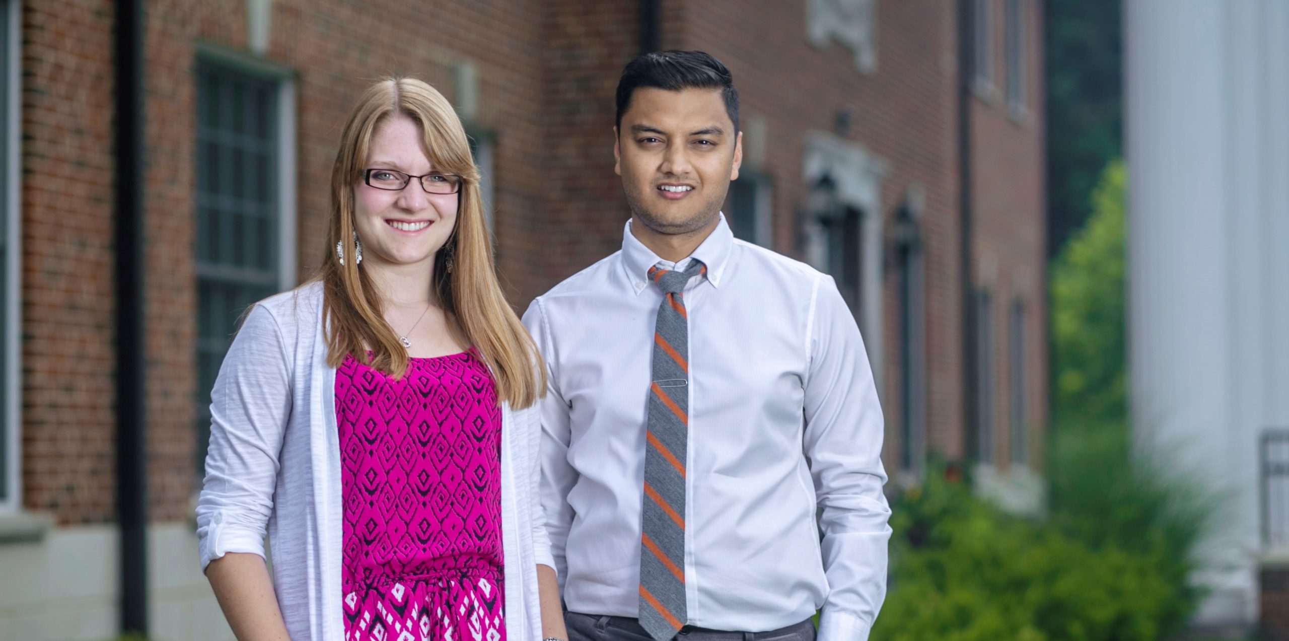 two students in front of college building