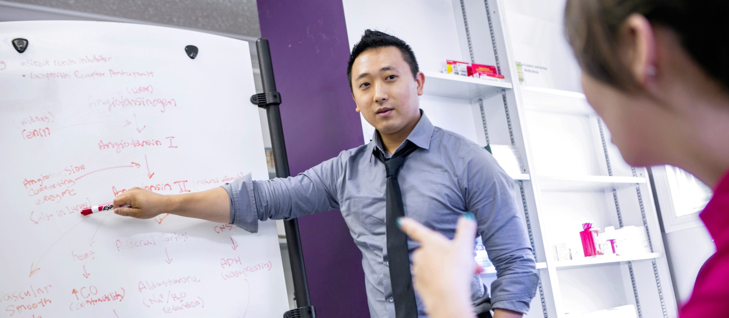 professor teaching at white board